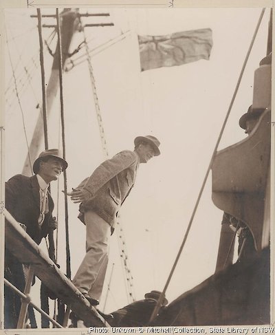 Madigan (left) and Mawson about to step from the rail of the Aurora onto the customs tender Adelaide